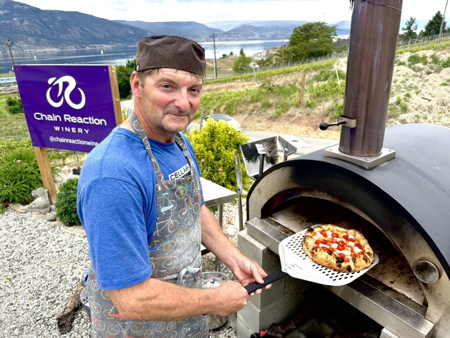 </who>Chain Reaction Winery co-owner and winemaker Joel Chamaschuk also mans the outdoor, wood-burning pizza oven.